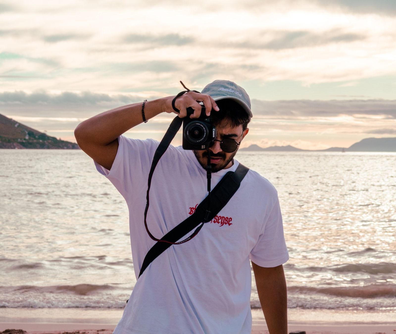 Levi, photographer and owner of Tremor Shots, holding a camera